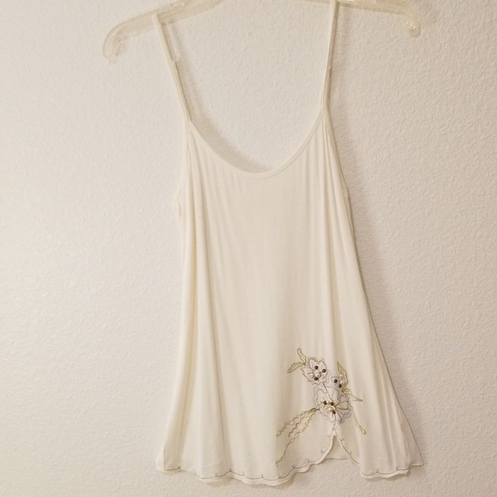 Cream tank with embroidery and beads bottom left.